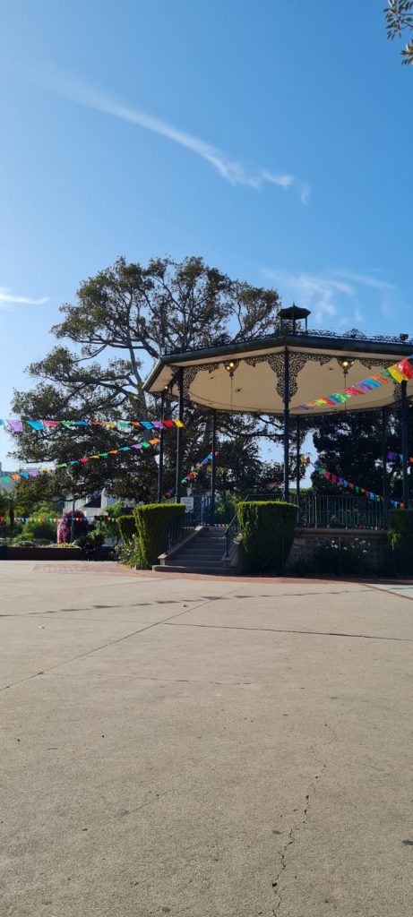 Photograph of a gazebo with colourful bunting attached.